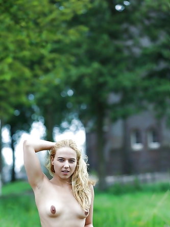 Blonde Euro teen Ivy stripping nude in grassy field before slut walk