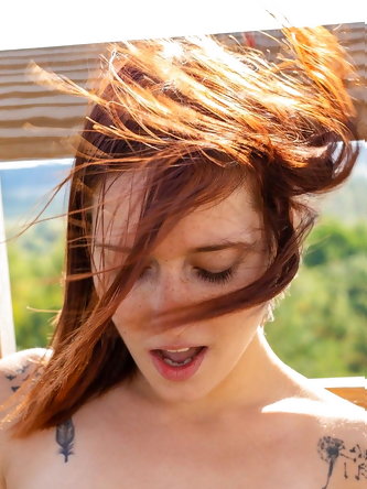 Amateur redhead with small tits Mina B fingers her cunt on a watchtower
