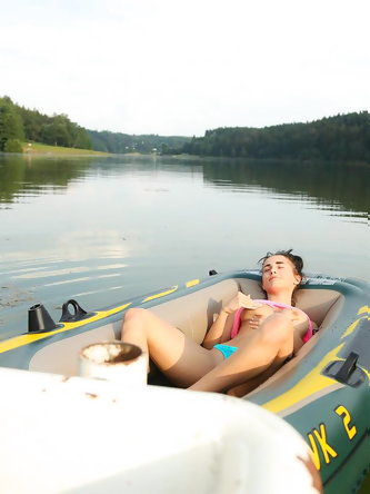 European teen with a flawless body relaxes in a small boat rubbing her snatch