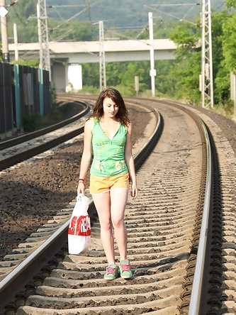 Barely legal girl strolls down railway tracks to find a place to masturbate at